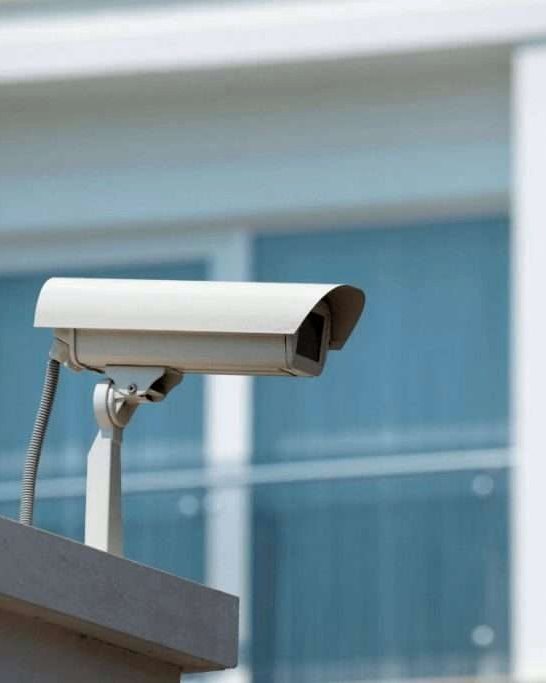 Security camera fitted under a building eave
